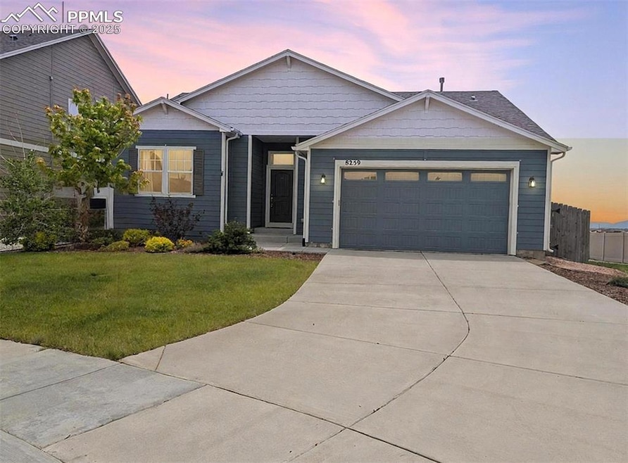 Ranch-style home featuring a garage and driveway