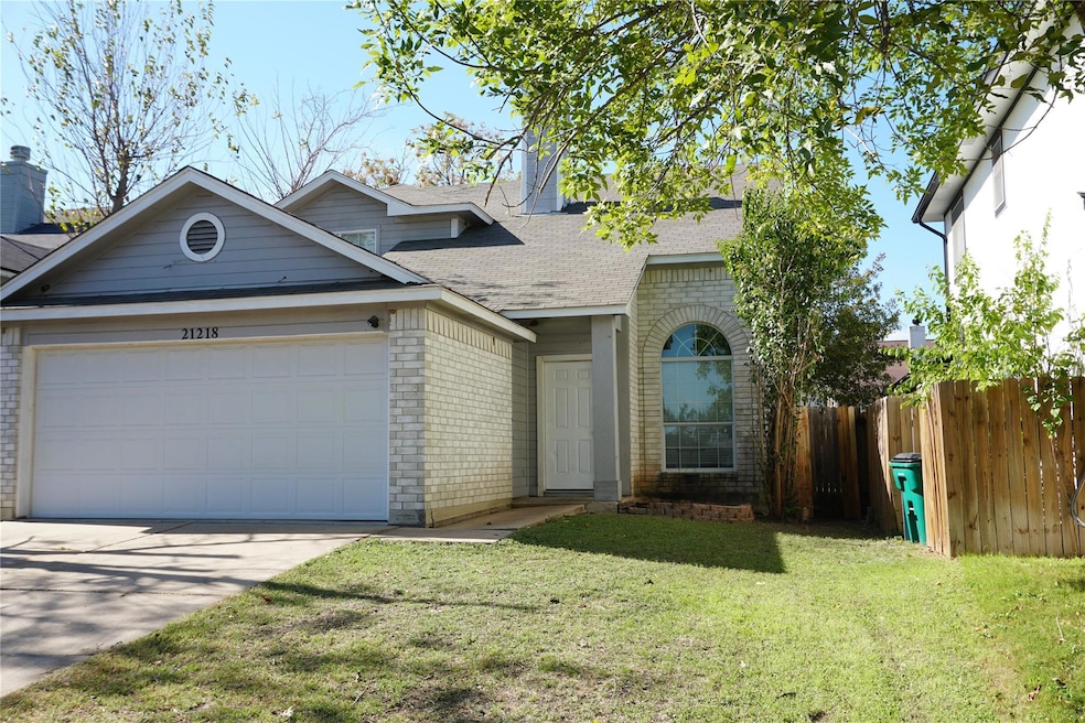 View of front of house featuring brick siding, concrete driveway, a shingled roof, and an attached garage