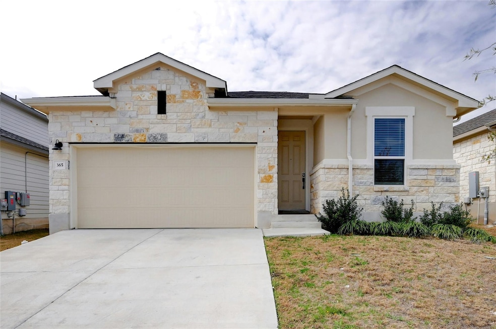 View of front of home featuring stone siding, an 
