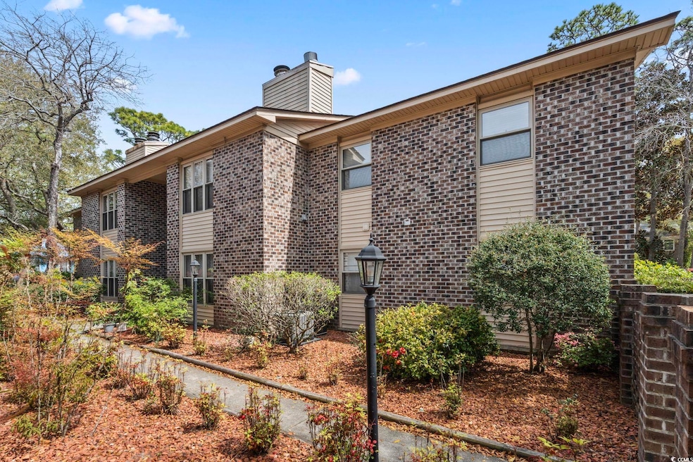 View of side of home featuring brick siding and a 