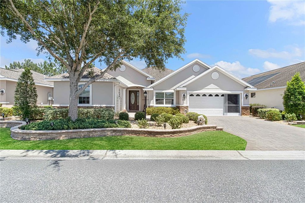 Front of home with custom curbing and beautiful la