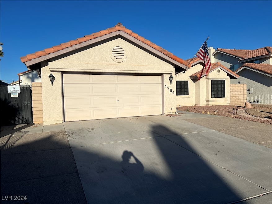 Single story home with stucco siding, concrete dri