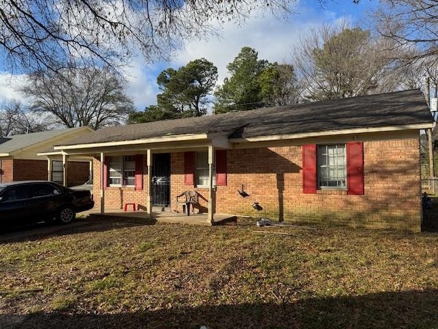 Ranch-style home with a front lawn and a porch
