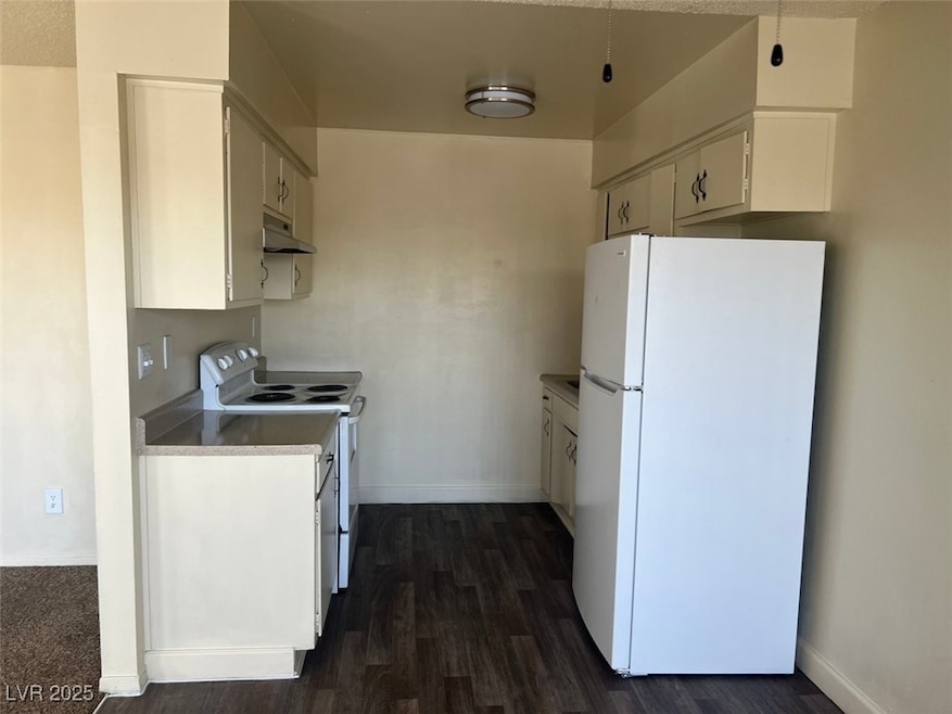 Kitchen with white appliances, under cabinet range