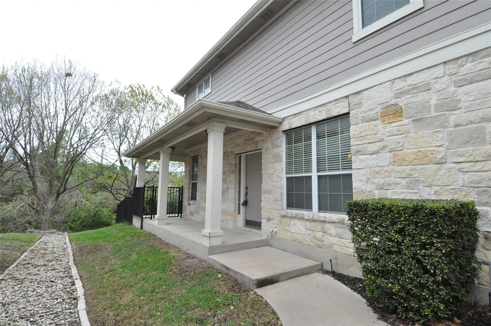 Doorway to property featuring stone siding and co