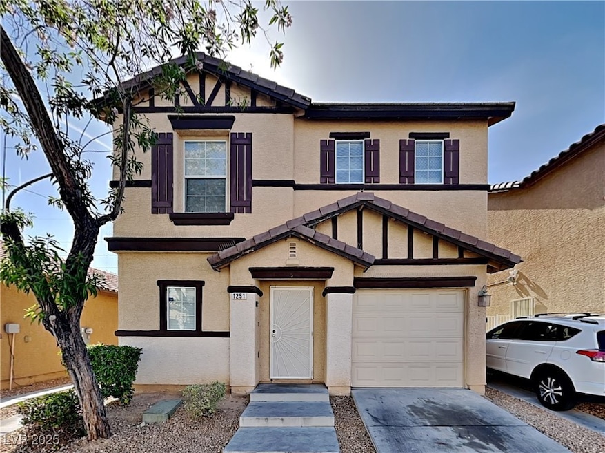 View of front of house with stucco siding, an attached garage, and driveway