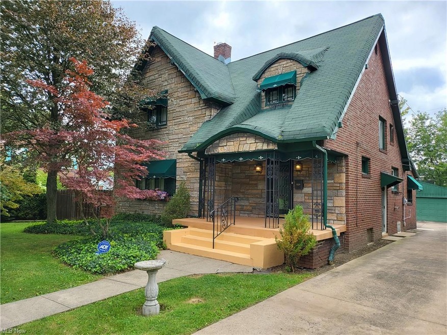 View of front of house with a front yard and garag