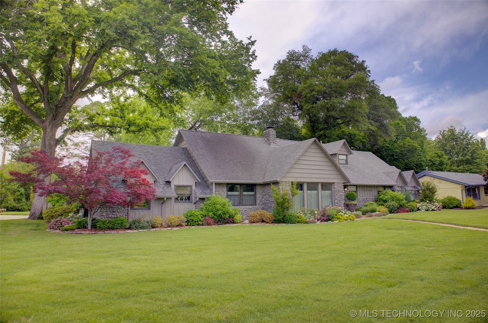View of front of home with a front yard, a chimney