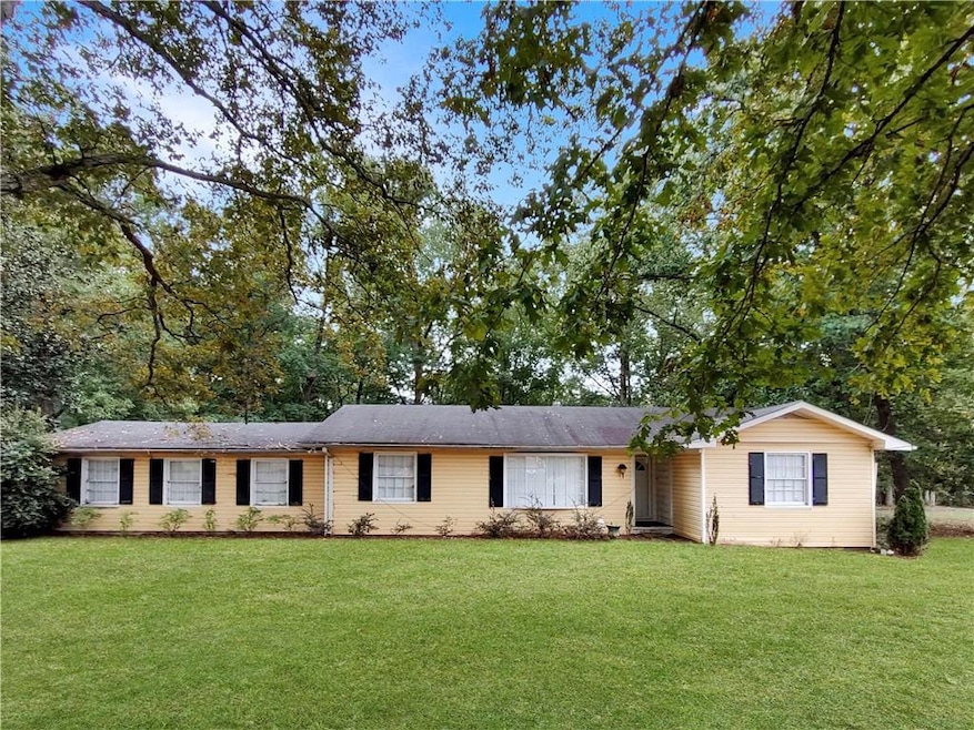 Ranch-style home featuring a front yard