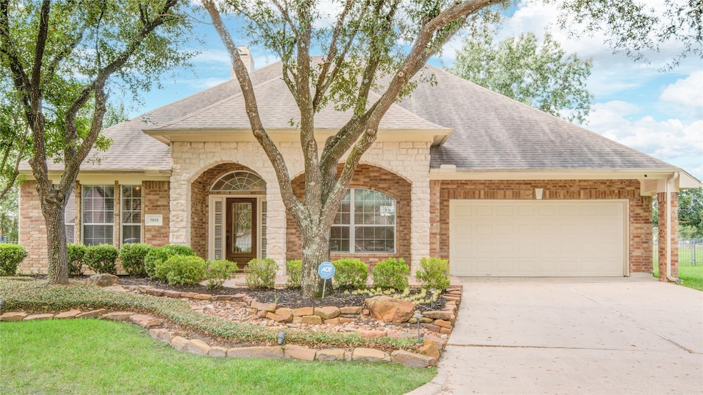 This charming brick and stone home is surrounded by mature trees and offers a 3-car tandem garage, nestled at the end of a quiet cul-de-sac.