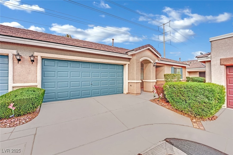 View of front of house with a garage, driveway, an