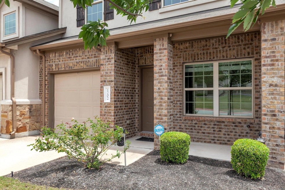 Property entrance with stucco siding, a garage, a