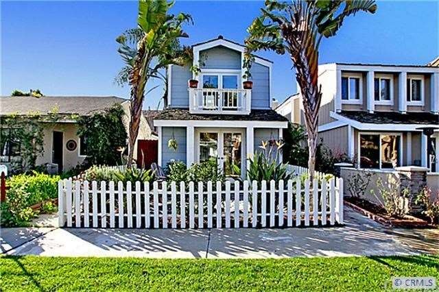 Tropical Paradise with white picket fence greets y