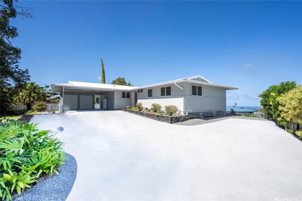 New concrete driveway leads to this charming Hilo 