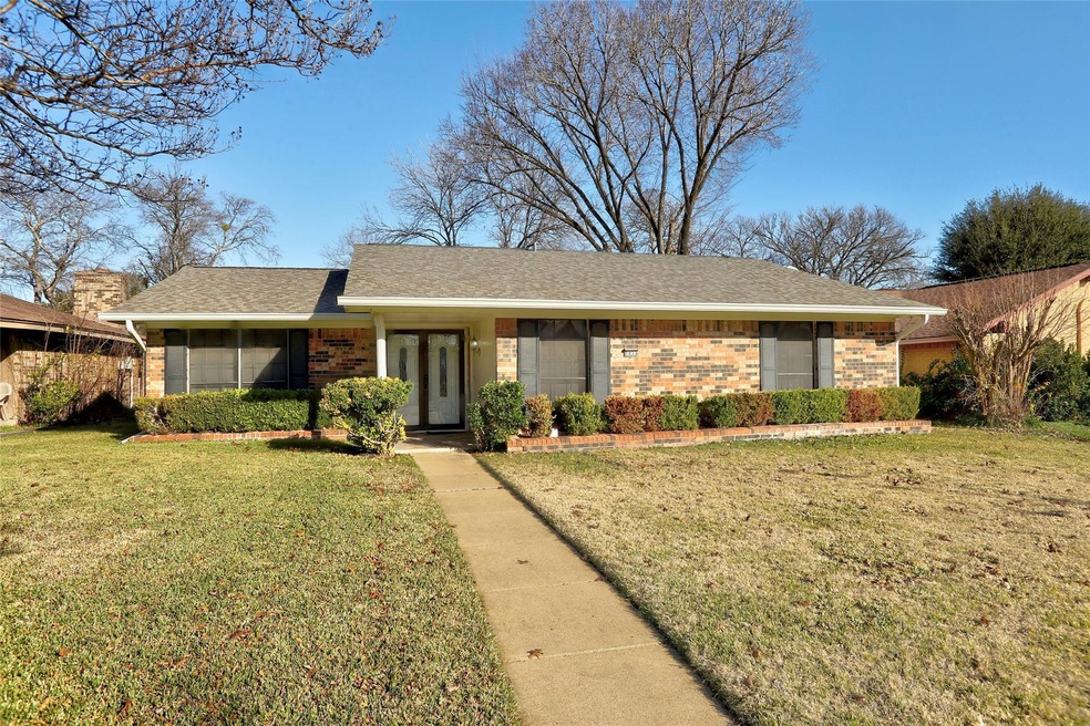 Ranch-style home featuring a front lawn