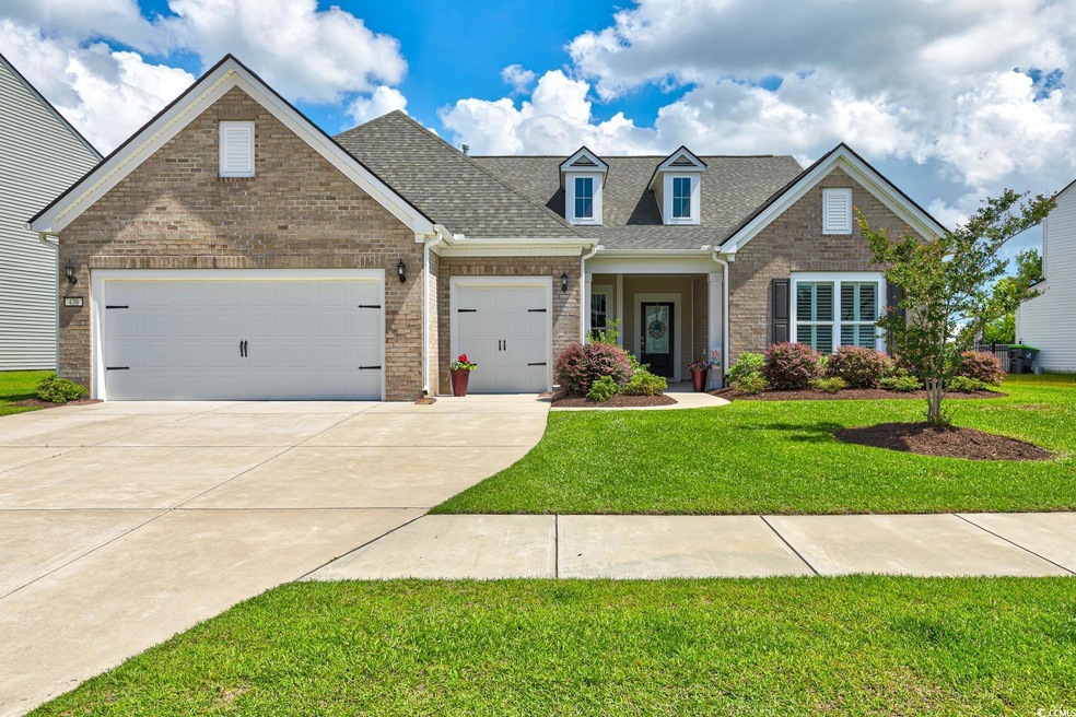 Craftsman-style house with a front lawn and a gara