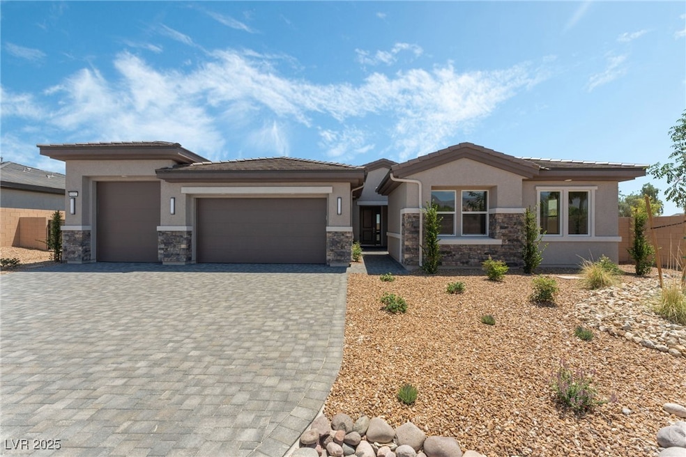 Prairie-style home featuring stone siding, stucco