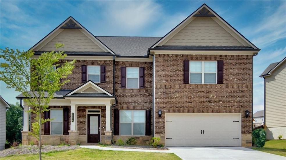 Craftsman-style home featuring brick siding, a garage, and concrete driveway