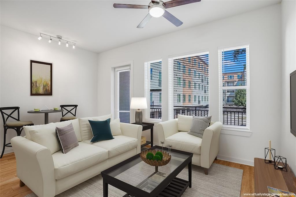Living room with baseboards, light wood-style flo