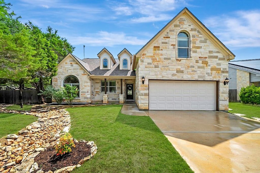 French country inspired facade with stone siding,