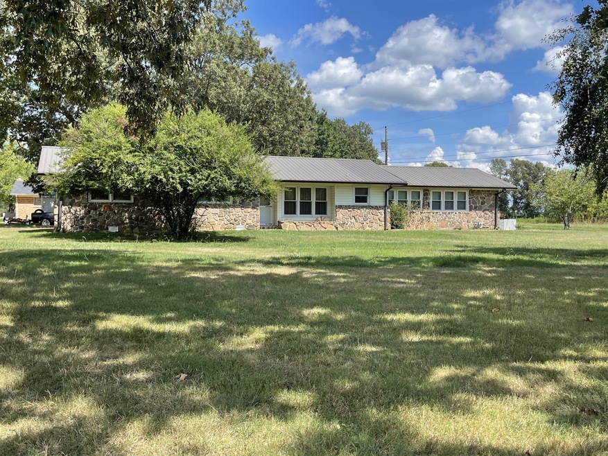 This unique stone/vinyl home is located on a corner lot with huge front yard and mature trees.