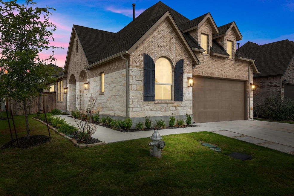 French country home featuring driveway, a garage,