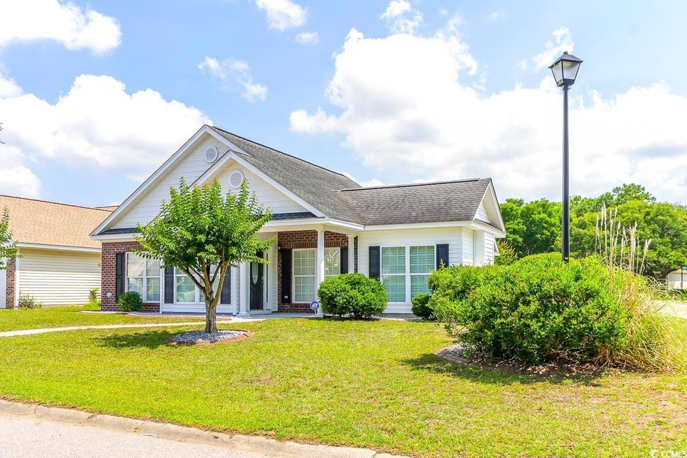 View of front of house with a front lawn, a porch, and roof with shingles