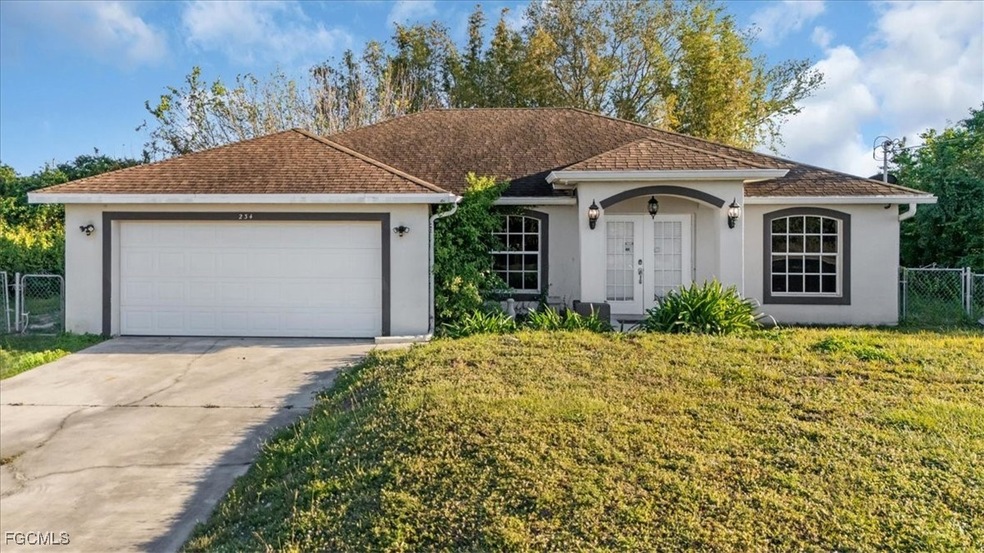 View of front facade with stucco siding, driveway, a garage, a gate, and a shingled roof