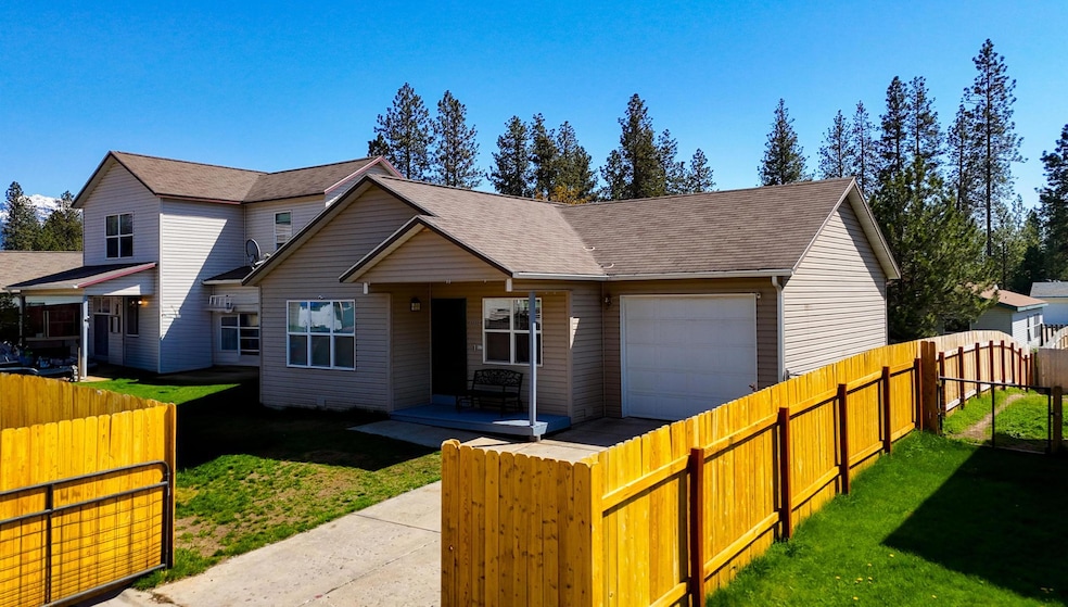 View of front of home with an attached garage, covered porch