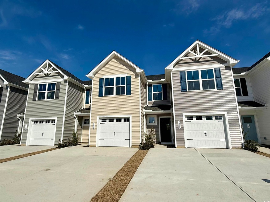 Townhome / multi-family property featuring an atta