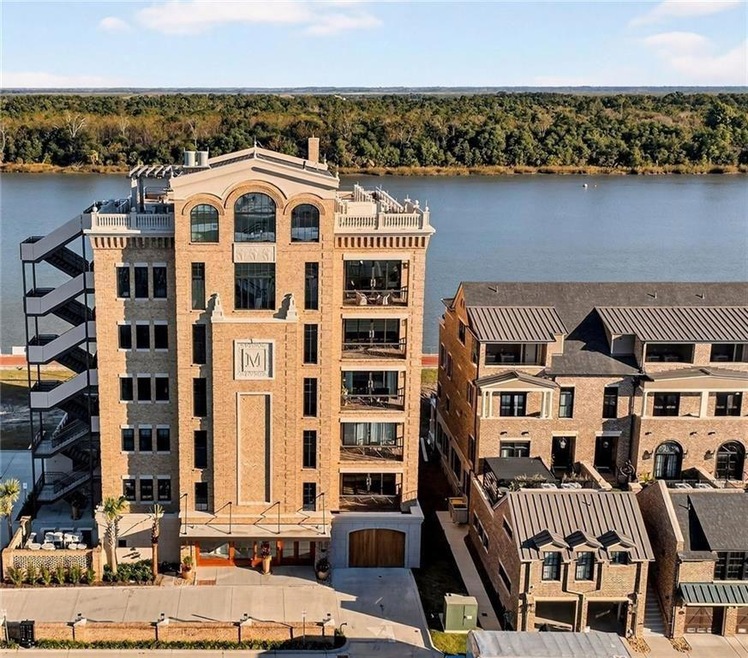 The Mayors Condominium - This stately riverfront residence boasts a commanding brick facade, private balconies, and scenic views-an elevated blend of historic charm and natural serenity.