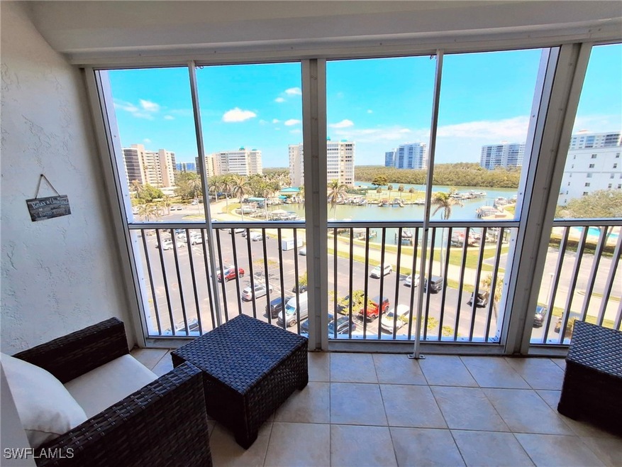 Sunroom featuring a city view and a water view