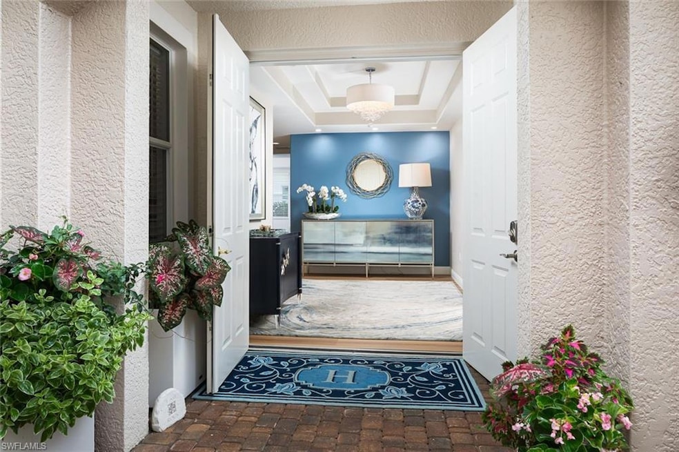 Doorway to property featuring stucco siding