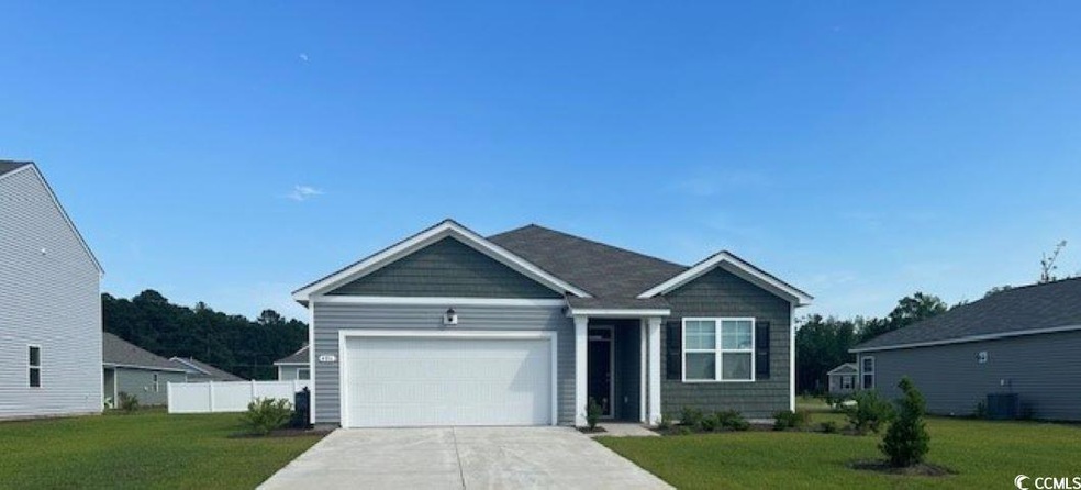 View of front facade with a garage and a front law