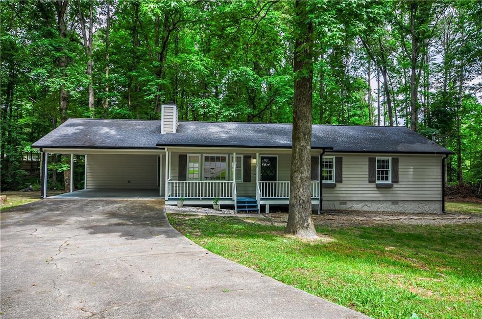 Ranch-style house featuring a carport and covered 