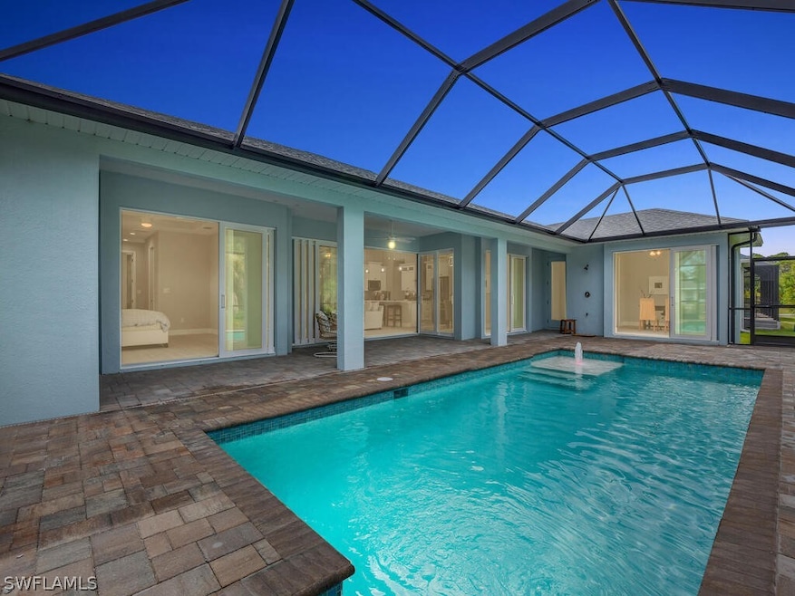 Pool at twilight featuring a patio and a lanai