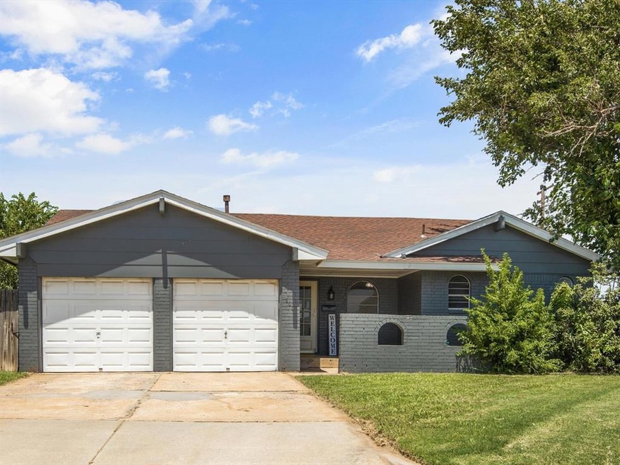 Single story home featuring a front lawn and a gar