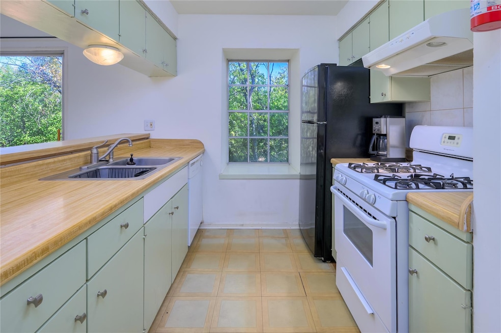 Kitchen featuring white appliances, under cabinet