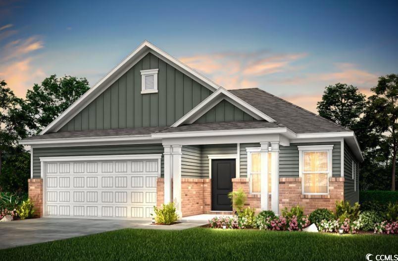 Craftsman inspired home with board and batten siding, brick siding, a garage, and concrete driveway