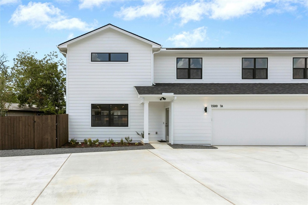 View of front facade with a garage, concrete driv