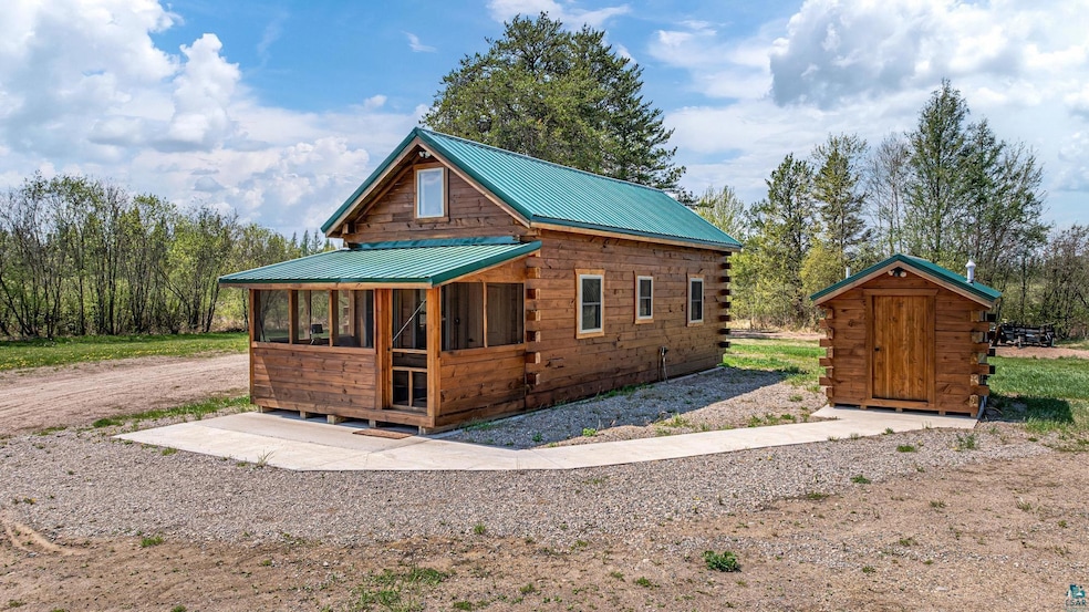 View of front of property with an outdoor structure and metal roof