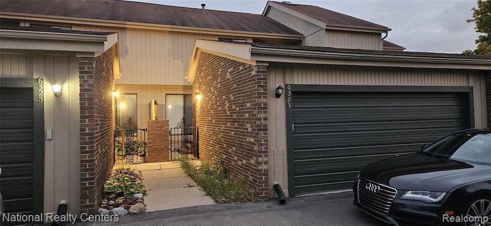 View of home's exterior featuring brick siding, roof with shingles, and an attached garage