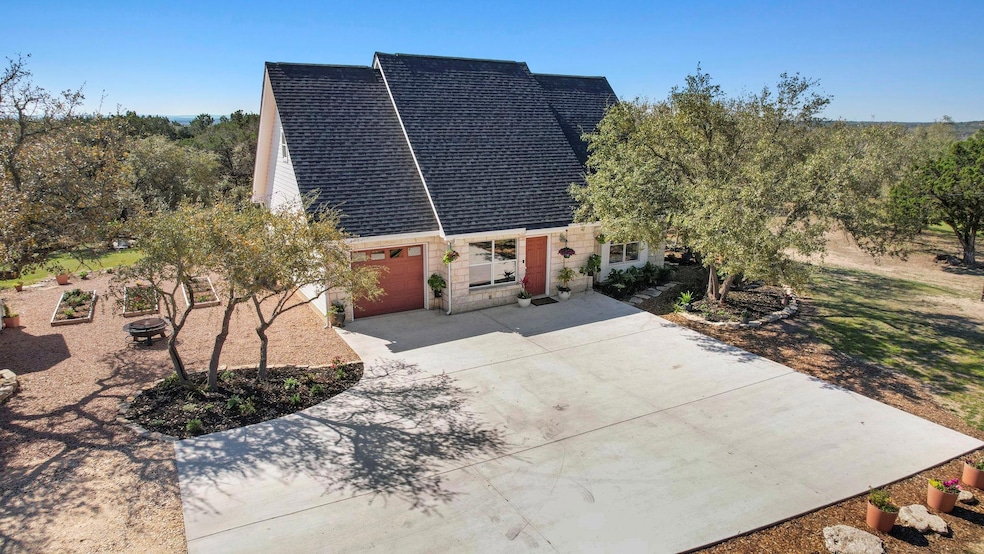 View of front of property with concrete driveway 