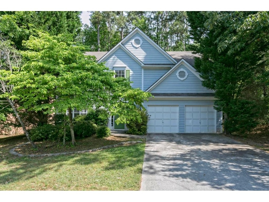 Exterior features blue siding, a two car garage, a