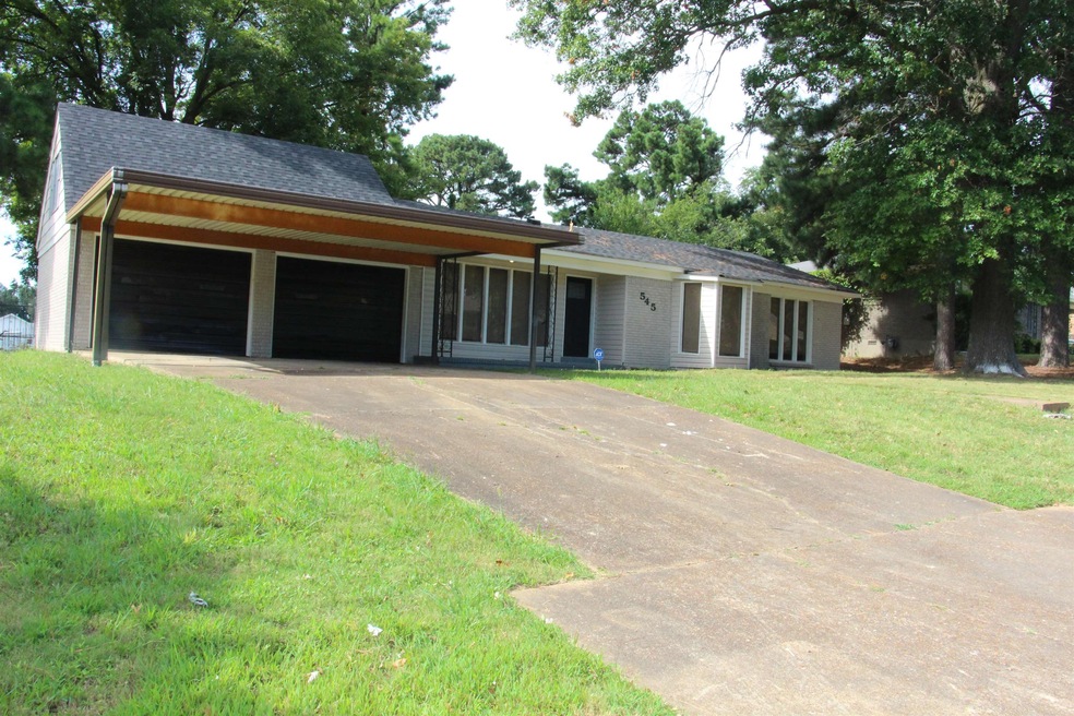 Single story home with a front lawn and a garage