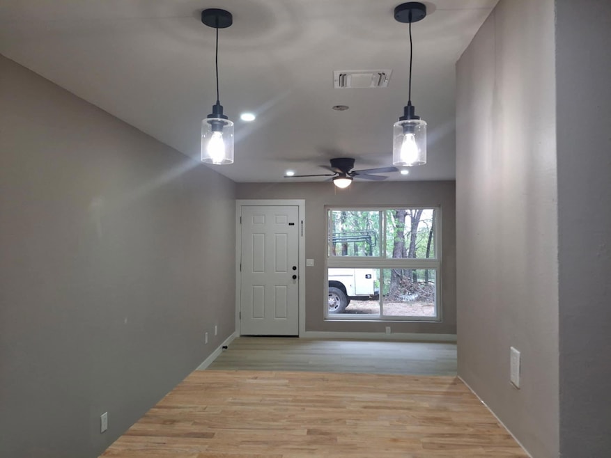 Entryway featuring light wood finished floors, ceiling fan, and recessed lighting
