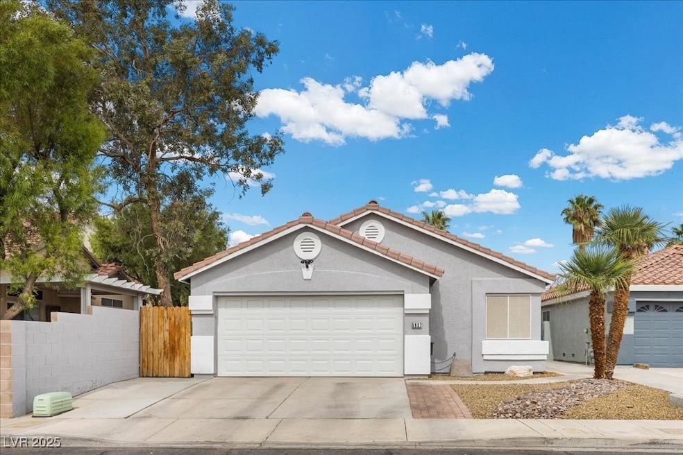Ranch-style home featuring stucco siding, driveway