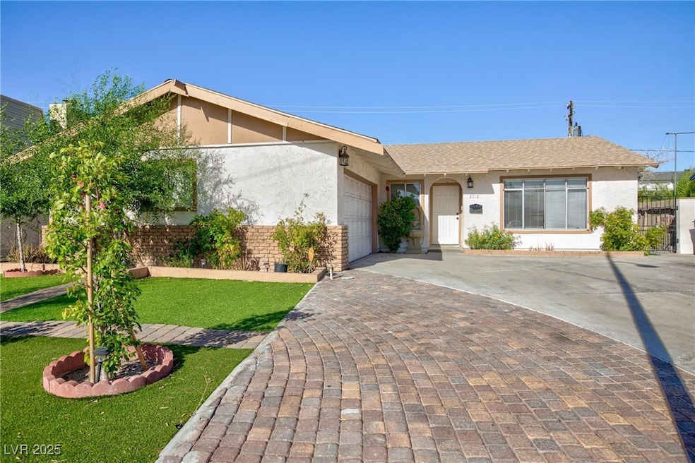 Ranch-style house featuring an attached garage, de