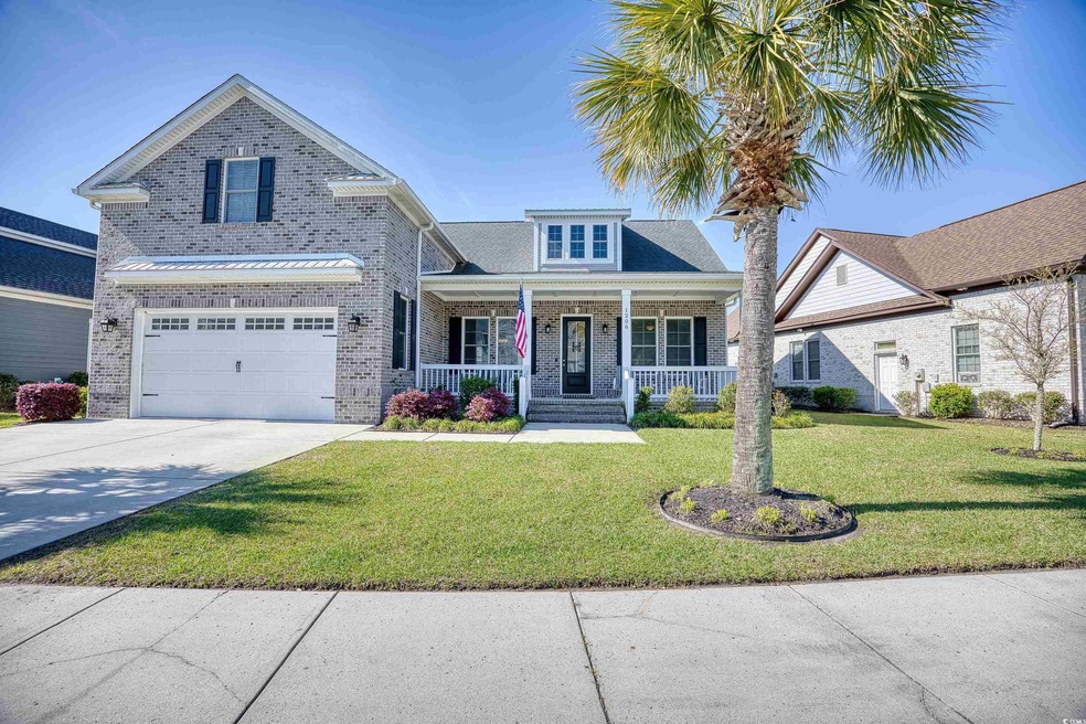 View of front of house featuring a front yard, cov
