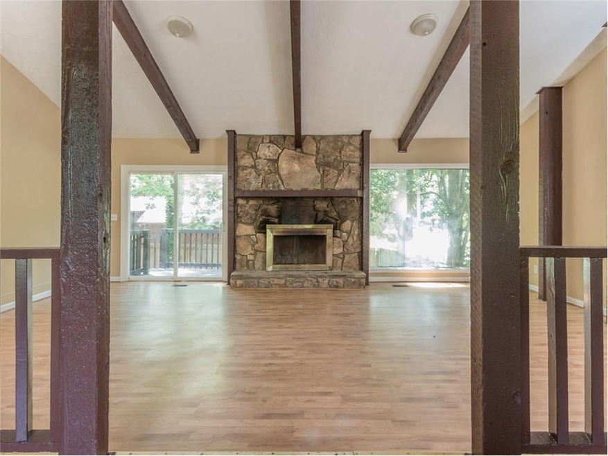 Huge Great Room with Cathedral Beamed Ceiling Picture Window overlooks fenced backyard